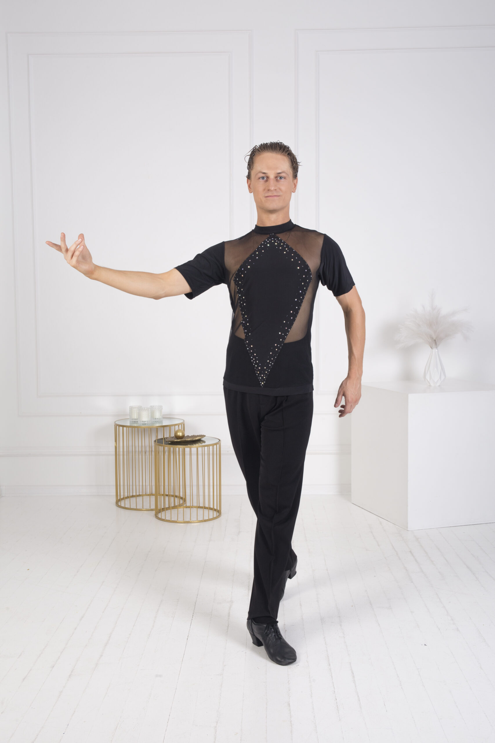 Man wearing a stylish black dance top with mesh and rhinestone details.
