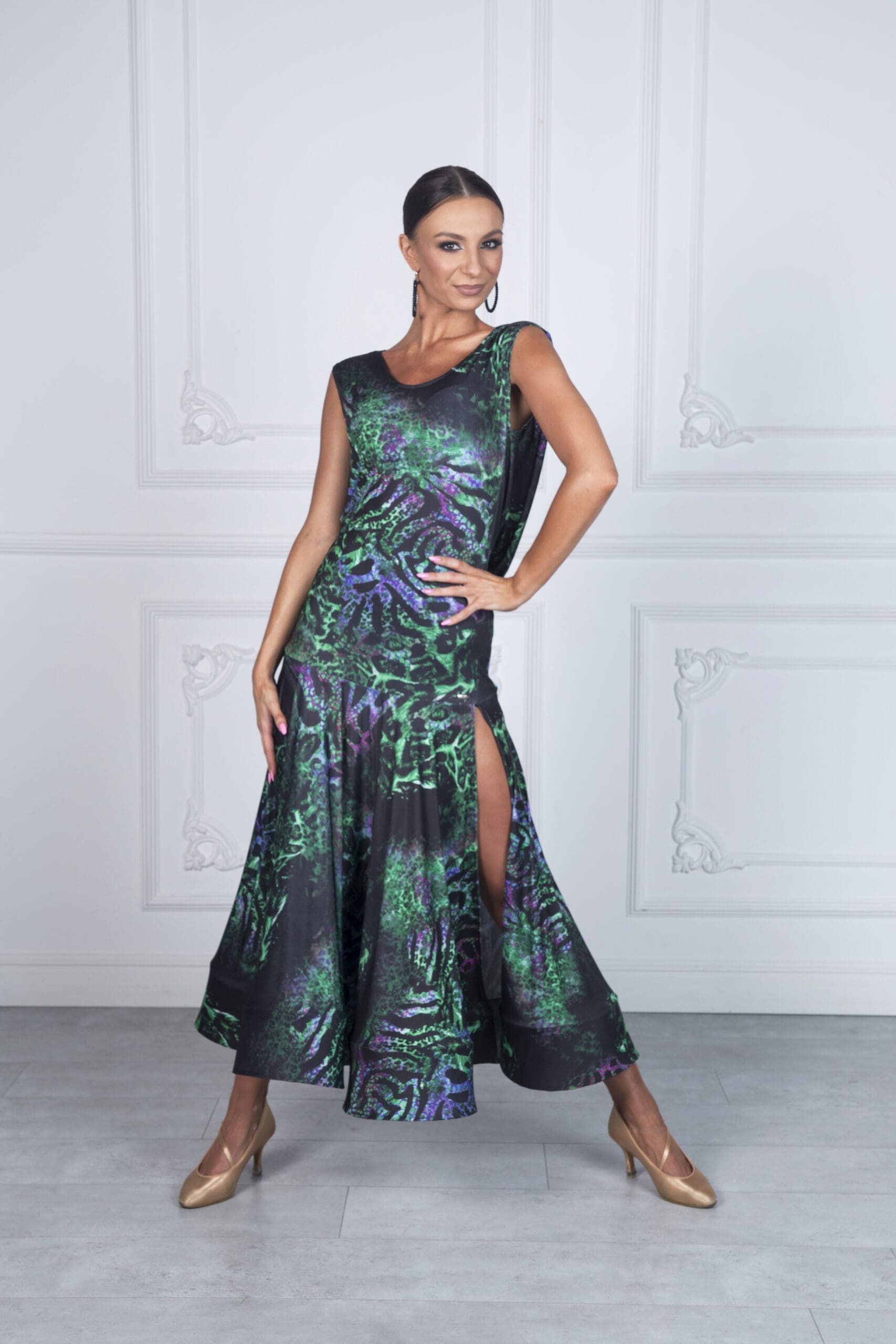 Model showcasing an elegant dance dress with vibrant green and purple patterns.