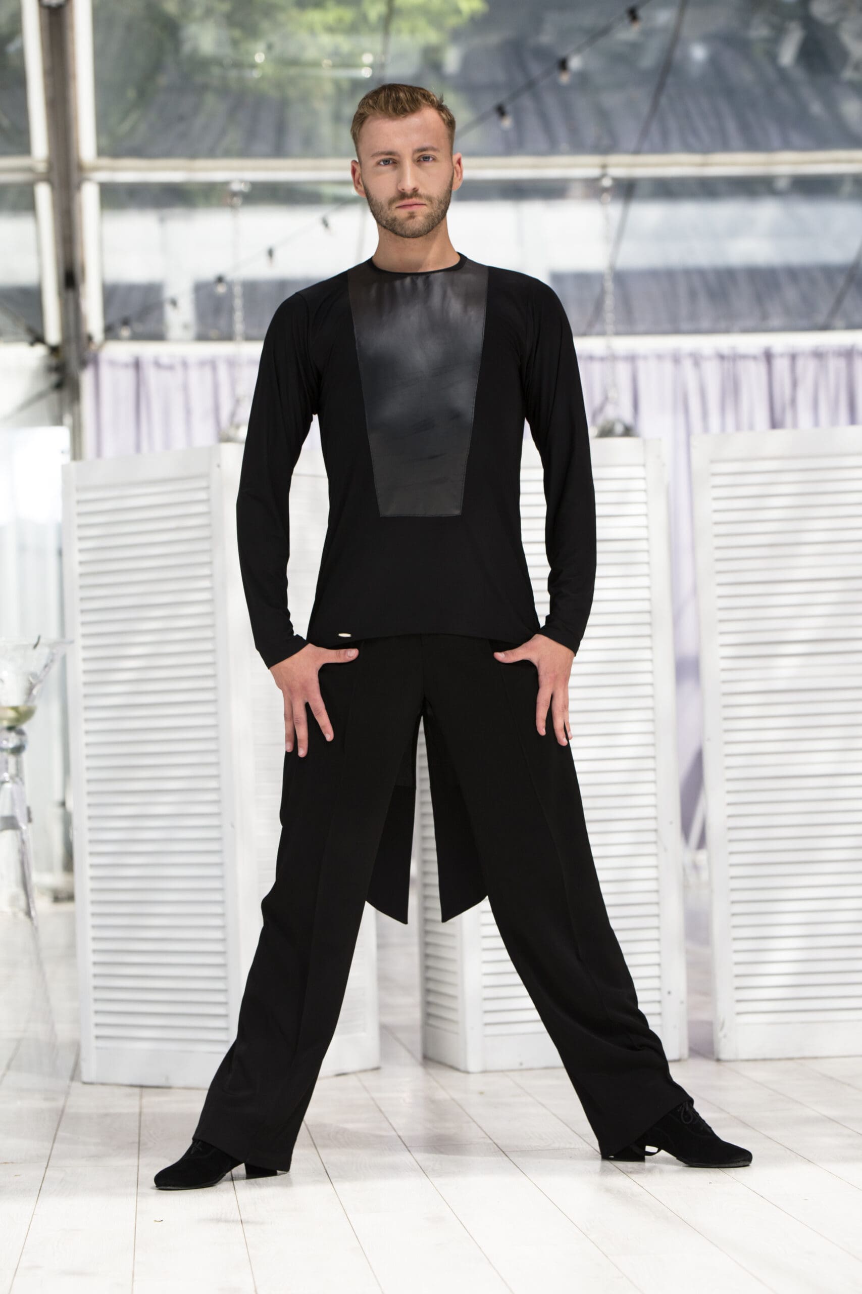 Elegant black dance outfit featuring a fitted long-sleeve top and flowing trousers.